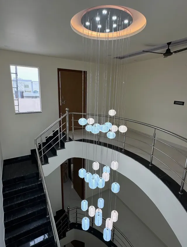 Curved staircase atrium with Jindal stainless steel railings, top view