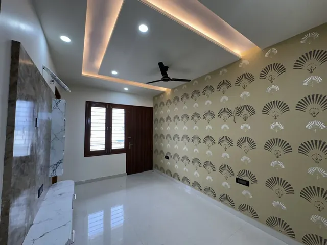 Bedroom with designer wallpaper and warm cove lighting