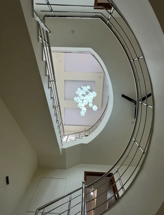 15-foot imported statement chandelier hanging through the staircase atrium